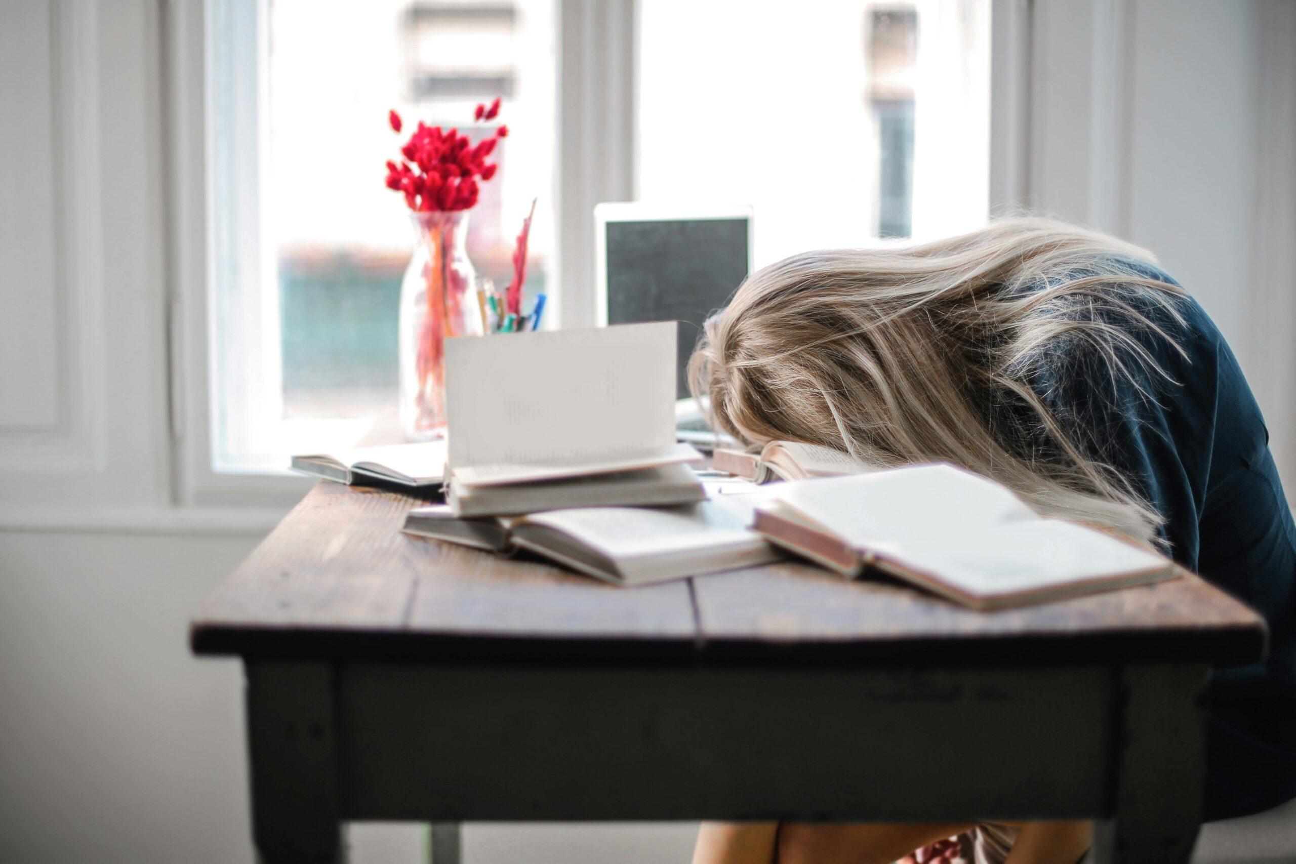woman with head on desk