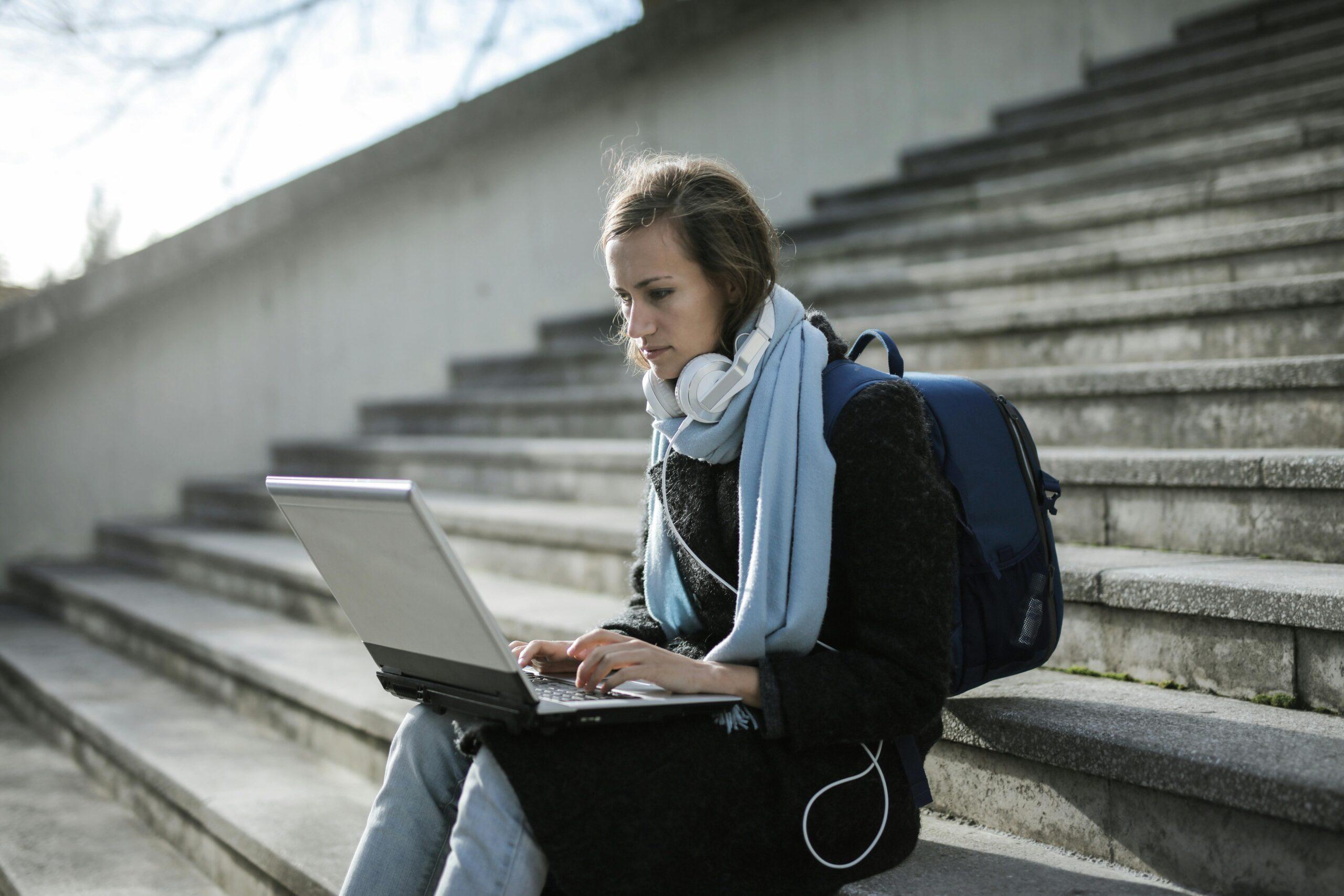girl with headphones sitting on steps
